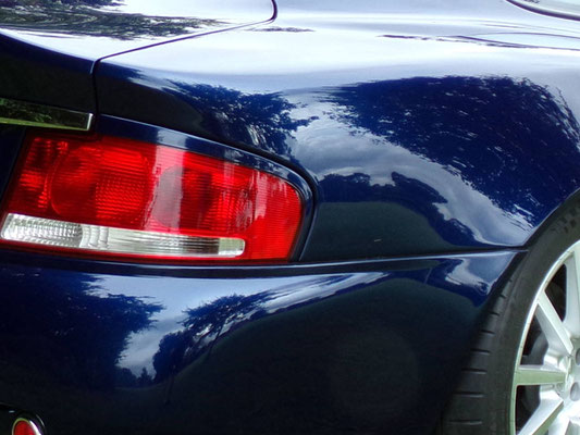 Close up of full body work by Precision Paint on a blue Aston Martin Vanquish S