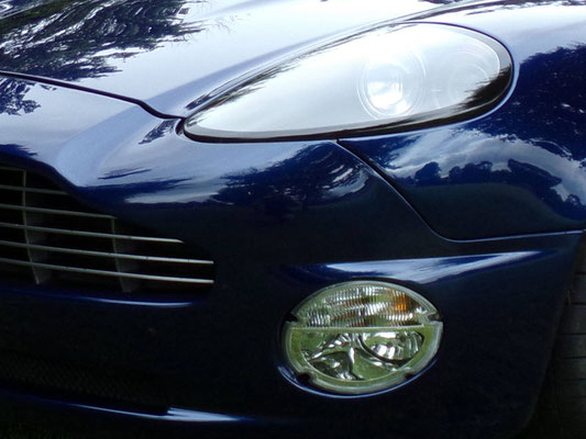 Close up of full body work by Precision Paint on a blue Aston Martin Vanquish S