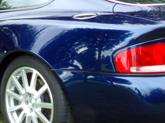 Close up of full body work by Precision Paint on a blue Aston Martin Vanquish S