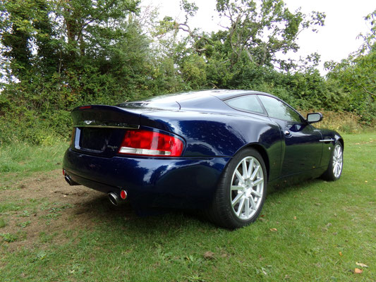 Back view of finished body repair work by Precision Paint on a blue Aston Martin Vanquish S