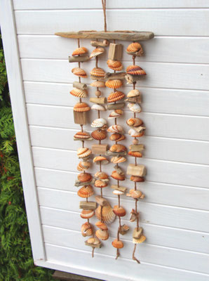 Die perfekte Sommerdeko: Hellbraunes Muschelwindspiel aus Treibholz, braun-weißen Muscheln, jede Muschel ist von Hand durchbohrt und aufgefädelt.