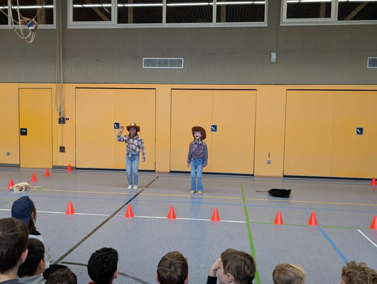 Zwei Kinder stehen als Cowboys da