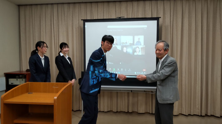 横山会長から主将へ援助の目録を贈呈