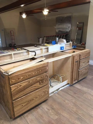 Cabinets done in Ash with "Chocolate" stain & lacquer finish. Island with Pot Drawers