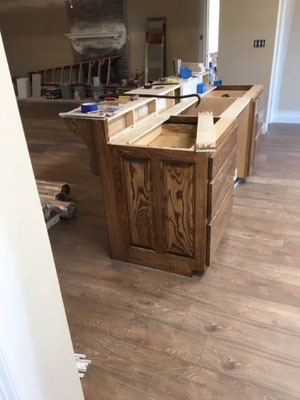 Cabinets done in Ash with "Chocolate" stain & lacquer finish. Side view of Island with counter to sit at.