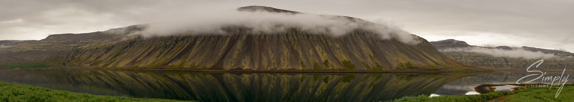 Patreksfjörður, Nebelbank in dem Fjord mit klarer Spiegelung.