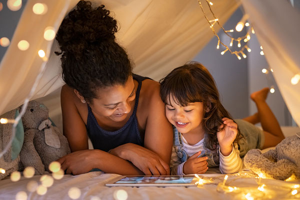 woman and girl reading in tent