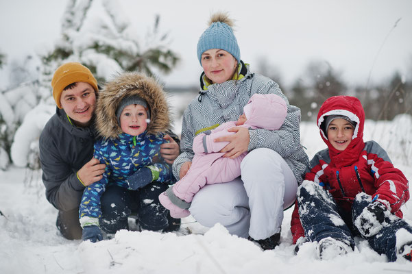 family dressed to play in snow