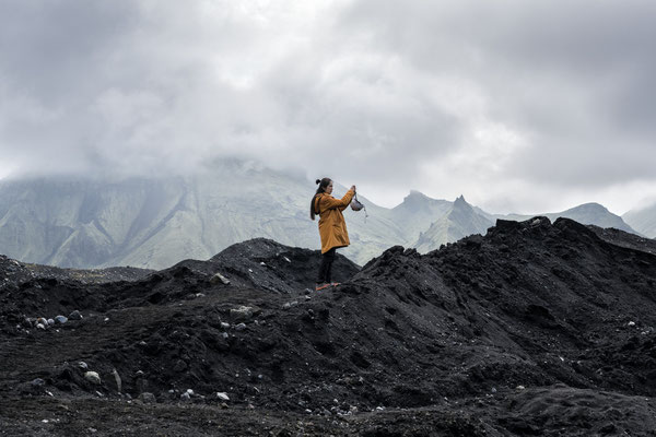 Iceland. A tourist photographs the landscape on a trip to the Katla Volcano.