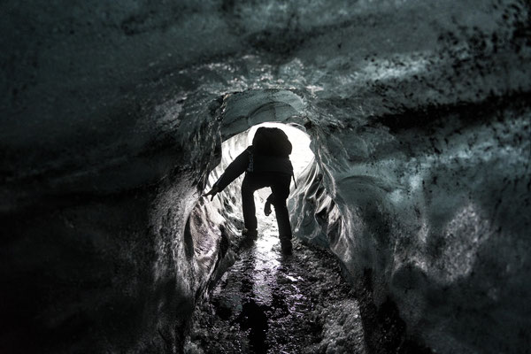 Iceland. A tourist emerges from the ice cave during a trip to the Katla volcano.