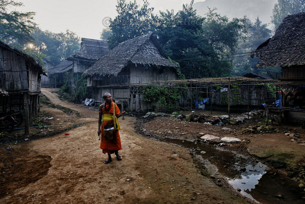 Buddhist monk while collecting offers for the temple, Mae La refugee camp, Thailand