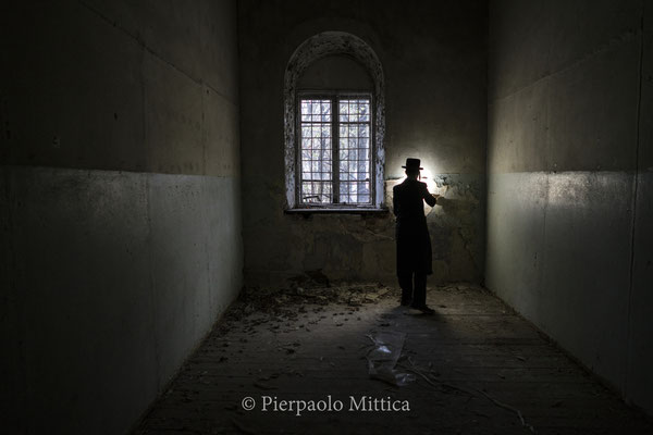 A Jew inside the Chernobyl synagogue. Chernobyl had 5 synagogue, which were destroyed during the pogroms and communism period. Only one is still standing today and under the Soviet period became a military recruitment center.