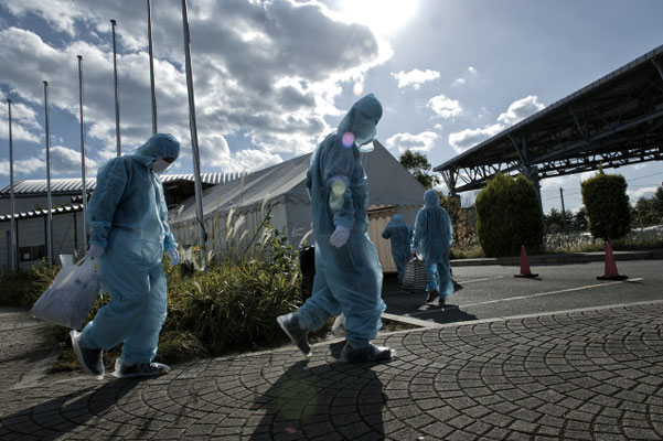 Workers coming back from their shift at the Fukushima nuclear power plant, J Village, Naraha.