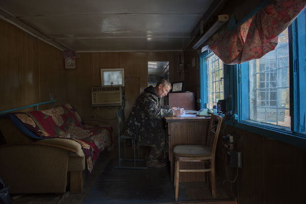 Inside the checkpoint at the ghost town of Pripyat. Victor has worked here as a guard for 7 years, his task is to control access, verifying that those who enter have the necessary permit. His shift last 12 hours.