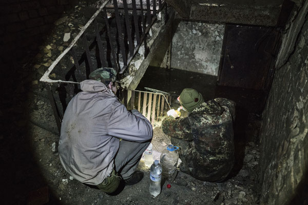 Jimmy and Sasha collecting water in the flooded basement of a house. Stalkers often drink this kind of water or rivers’, dirty and contaminated.