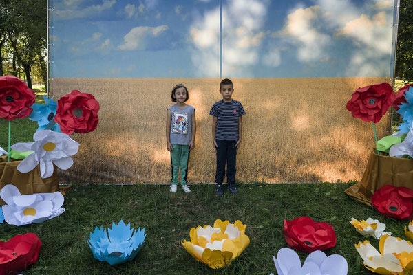 Children while taking a souvenir photo in front of the Ukrainian flag during the local Ivankiv fair. Ivankiv.