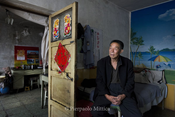 Chang Shuqing, 69 years old, at his home in Qiabuqi. Chang Shuqing was a miner, now is retired. He has always lived in the village of Qiabuqi. The government promised him a new apartment in Wuhai City in 2012, and he is still waiting to be transferred