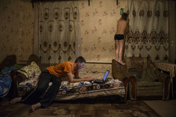 Igor with his father Sasha in their home in the contaminated village of Radinka.