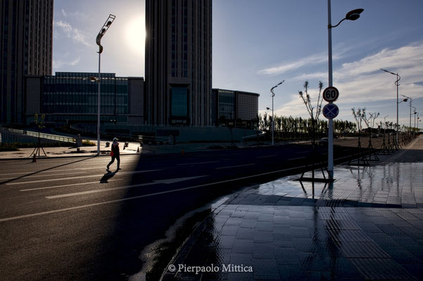 a street sweeper in the empty streets of Kangbashi, Ordos district