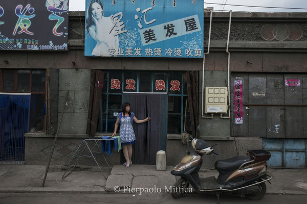 In the semi-evacuated town of Gongwusu, near the coal mines, hairdresser never propose black hair dye