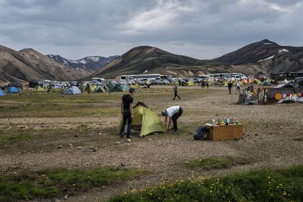 celand. Hikers at the Landmannalaugar base camp, a hiking centre open during the summer. Since 1951 it has also served as a mountain hostel and can host up to 78 people. The area is a popular tourist destination because of its geological formations