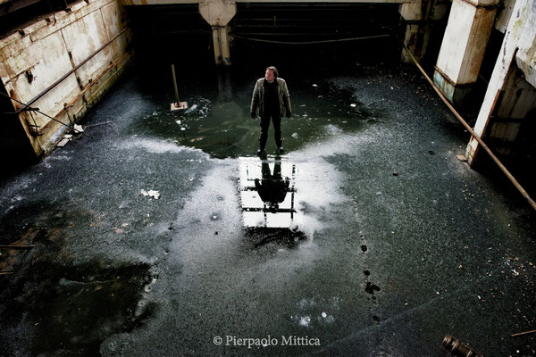 Yuriy Tatarchuck on ice inside the abandoned electronics factory. The whole basement is flooded and during the winter becomes a slab of ice, where it is possible to walk. Pripyat, exclusion zone