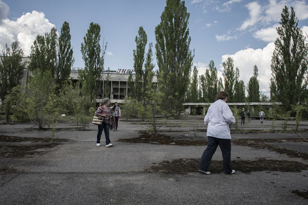 Former inhabitants of the city of Pripyat while strolling in the main square of their city.