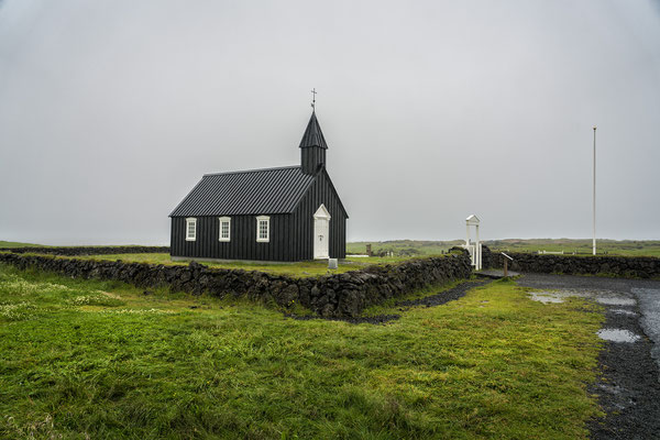 Iceland. The Black Church in Búdir, considered a national monument and situated in the middle of a lava field. It was built by Bent Lárusson in 1703.