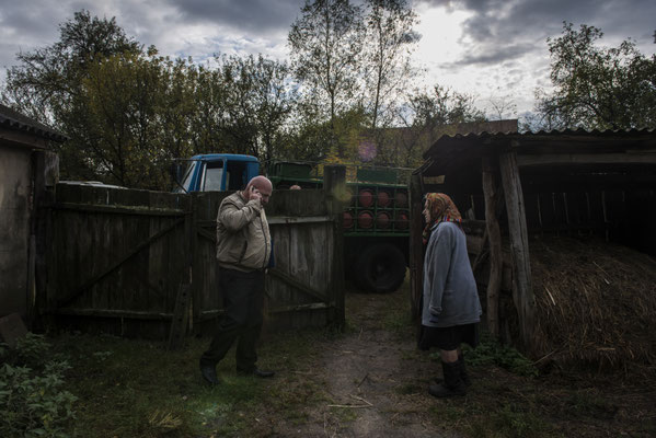 Maria Semenyuk while purchasing a gas bottle from a seller of the zone. Paryshev, Chernobyl Exclusion Zone