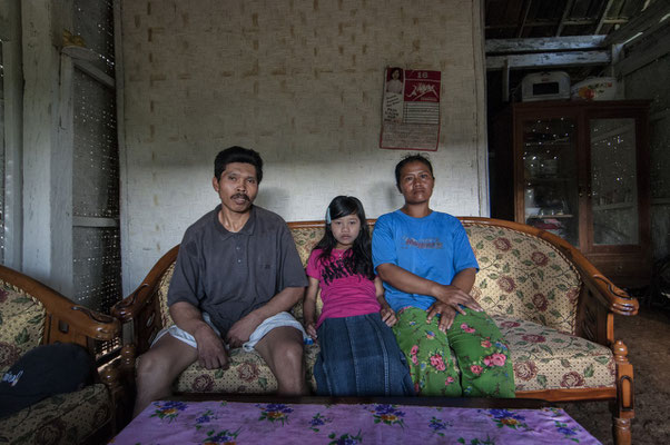 Sutikno with his son and wifeat home, he lives in Tanah los village