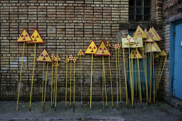 Fresh painted radiation warning signs ready to be put around the zone, Pripyat city. In the ghost  town of Pripyat, inside Chernobyl Exclusion Zone, there is a factory where workers paint the radiation warning signs worn by time and weather. 