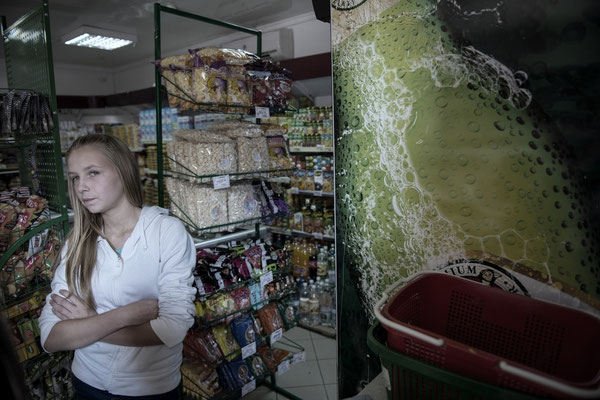 Nadia in the Dobrush village grocery store buying food for her family.