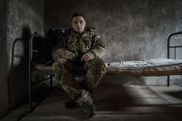Maxim resting exhausted in the abandoned pig-shed after a 20 km march in the woods