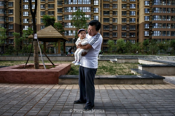 Mr. Lin with his grandson in the social houses in the new district of Kangbashi, Ordos