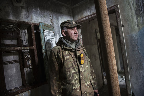 Vladimir, a former resident of the city of Pripyat, in front of the apartment where he lived with his parents before the accident. Pripyat.