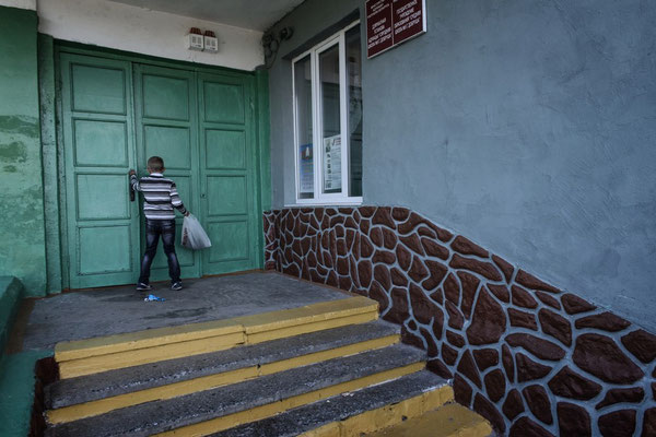 A child enters the Dobrush school, the school serving the Dubovy Log village.