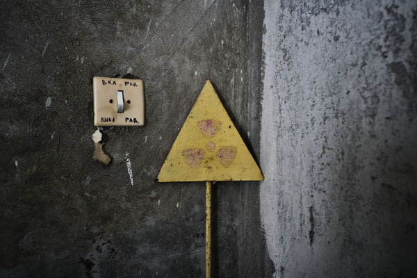 A sign of radioactive hazard inside Jimmy’s apartment in Pripyat. Stalkers often collect objects they found in Pripyat to decorate their apartments and make jokes about radiations to dispel the problem. On this light switch, Jimmy wrote: radiation on/off 