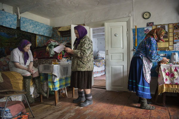 Hanna with Maria and her sister Sofia in her house preparing the mushrooms for lunch, Kupovate village. Chernobyl Exclusion Zone.