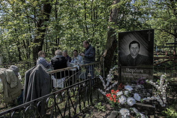 Former inhabitants of the city of Chernobyl feast on the graves of their dead according to the Orthodox tradition. Chernobyl city cemetery.