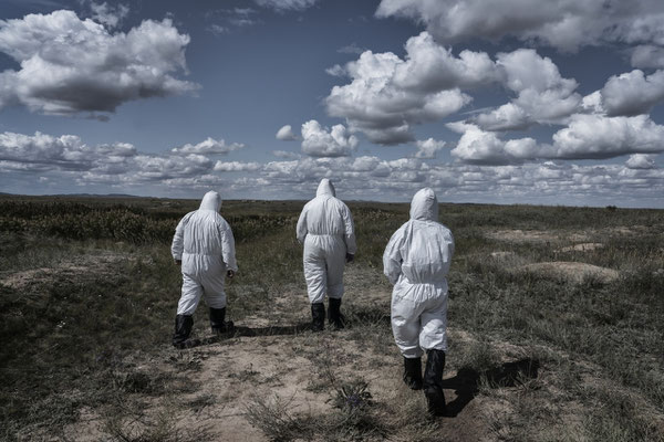 Scientists of the Kurchatov nuclear center wearing protective suits Inside the polygon, while going to ground zero, where the first atomic bomb was exploded on 1949.