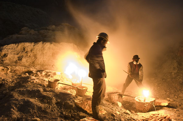 miners while collecting chunks of sulphur in the volcano crater during his night shift