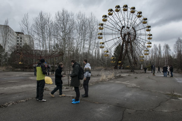 Tourists in the square of Ferris wheel in Pripyat.