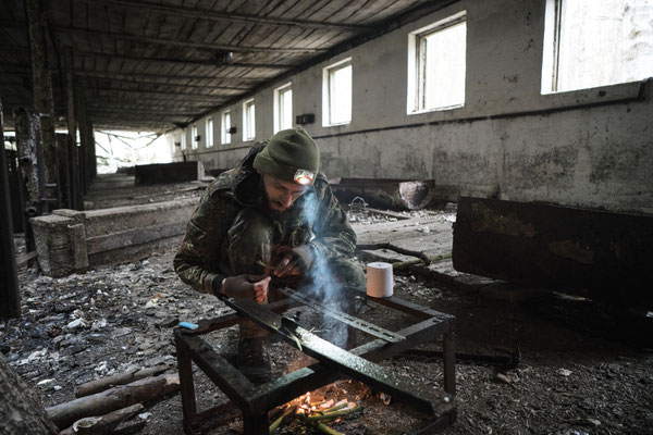 Jimmy lighting fire in an abandoned pig-shed
