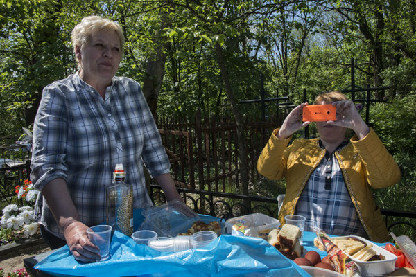 Former inhabitants of the city of Chernobyl feast on the graves of their dead according to the Orthodox tradition. Chernobyl city cemetery.