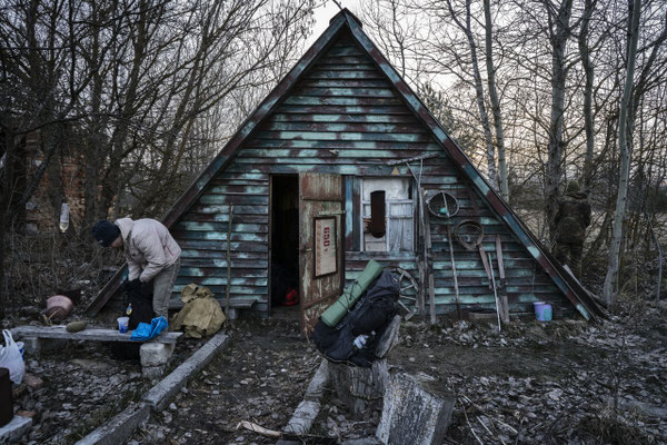 Sasha in front of the foresters cabin while preparing his backpack before heading to Pripyat