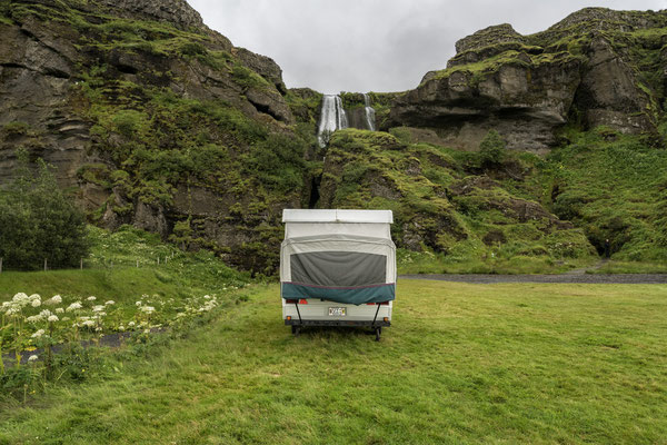 a caravan parked on the campsite in front of the Gljúfrafoss waterfall. Gljúfrafoss is a small waterfall located about 600 meters north of the more famous Seljalandsfoss, in the southern part of Iceland.