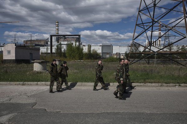 Chernobyl, workers head to the canteen at the nuclear power plant for their lunch break. Their route takes them past reactor 4.