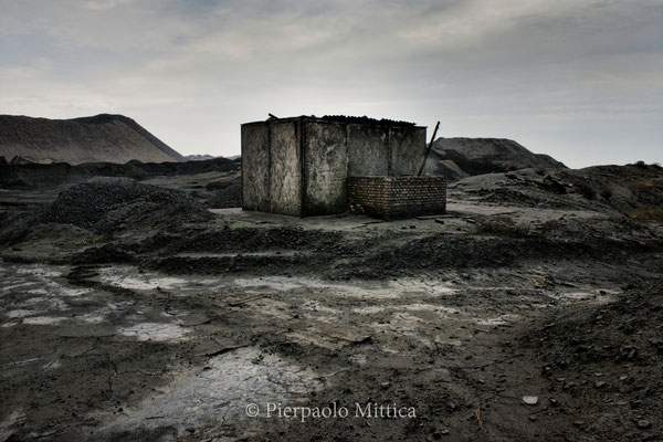 A coal mine abandoned because of the fossil market crisis. Locations in similar conditions are growing in number, and they all present a sky-high level of pollution and toxicity