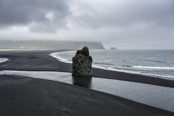 Iceland. A rocky stack on the picturesque Reynisfjara black beach, one of the country’s most famous tourist attractions.