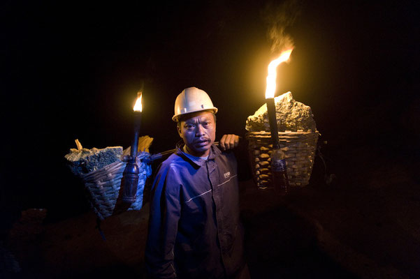 Asrin ready to climb up the crater with his sulphur load during his night shift